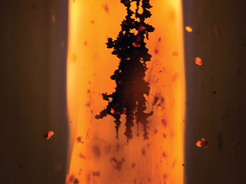 Dendritic Growth of a Soot Fractal in Negative Gravity